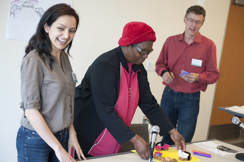 Group of three happy people who attended one of the events of this master's program