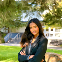 Tamanna Shirol, young woman in a grey suit on SFSU campus