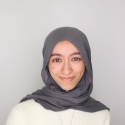 Tasnim Saada, MA Design Graduate Student, in grey hajib and white sweater