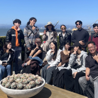 Eleven students from MCTU, with Professor Zun-Hwa Chiang, on a San Francisco rooftop lounge overlooking the Bay