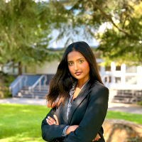 Tamanna Shirol, young woman in a grey suit on SFSU campus